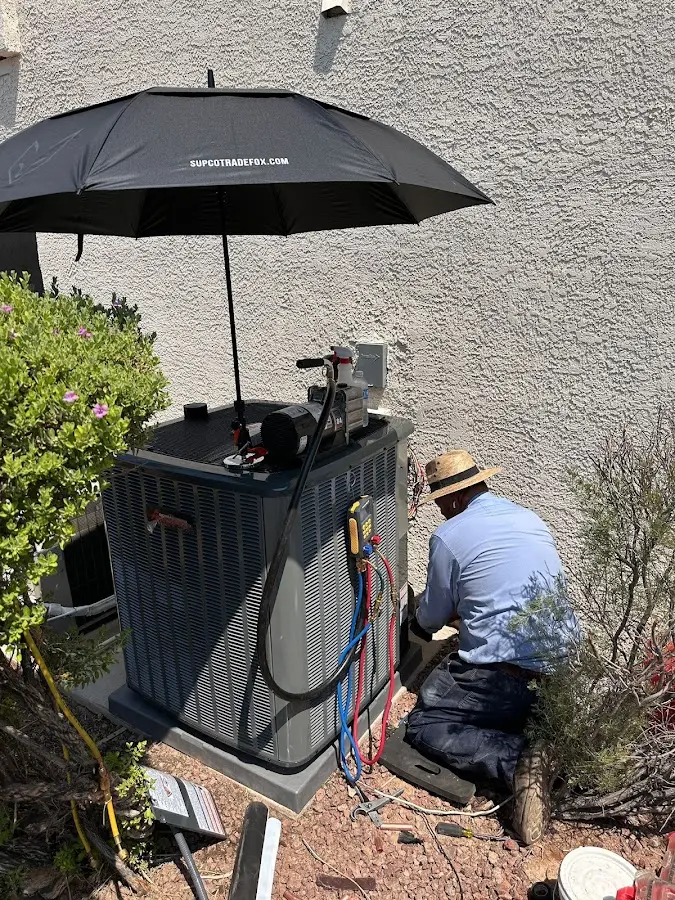 HVAC technician performing outdoor AC maintenance in Seaside